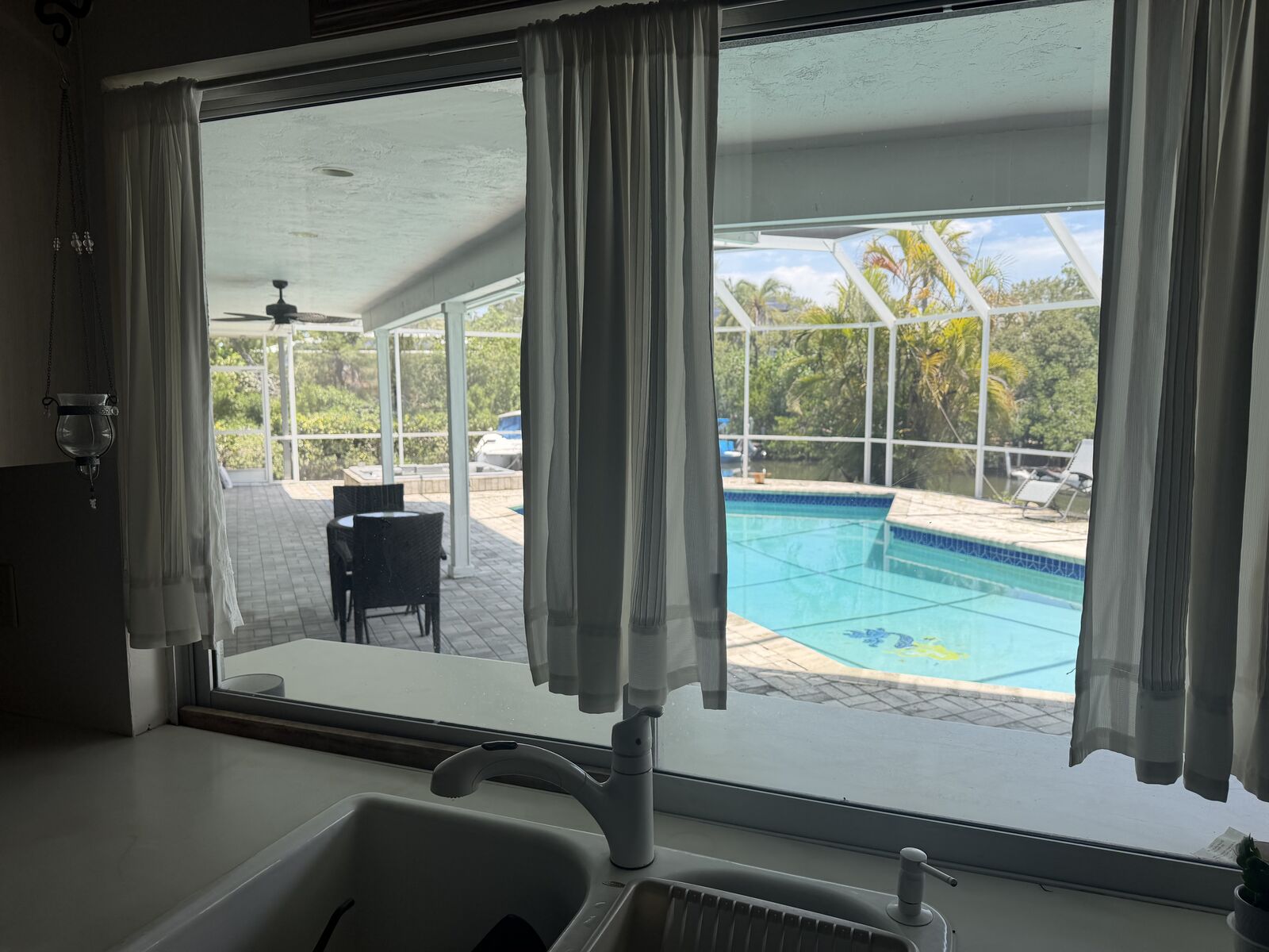 Open living and dining room with sliders to the pool