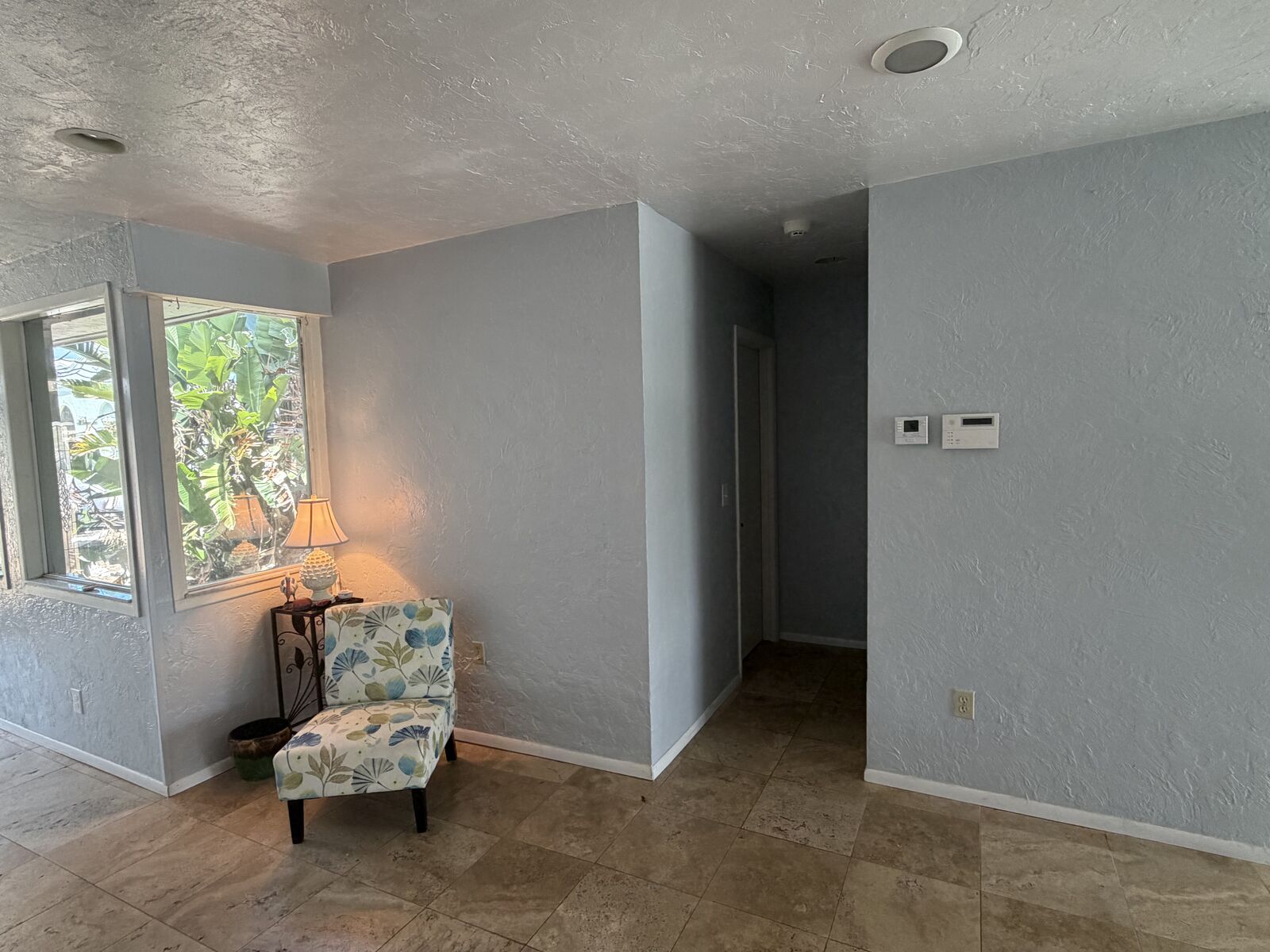 Hallway with custom finishes leading to the kitchen