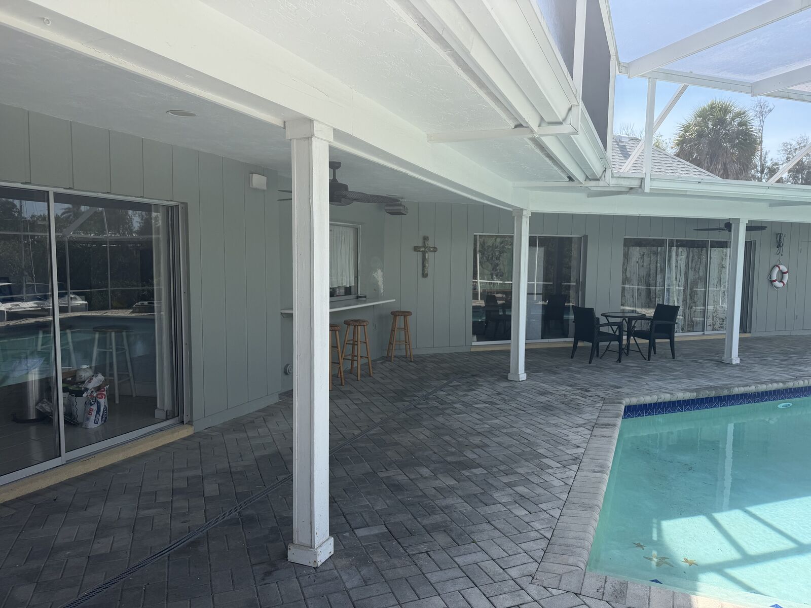 Covered outdoor patio next to the pool