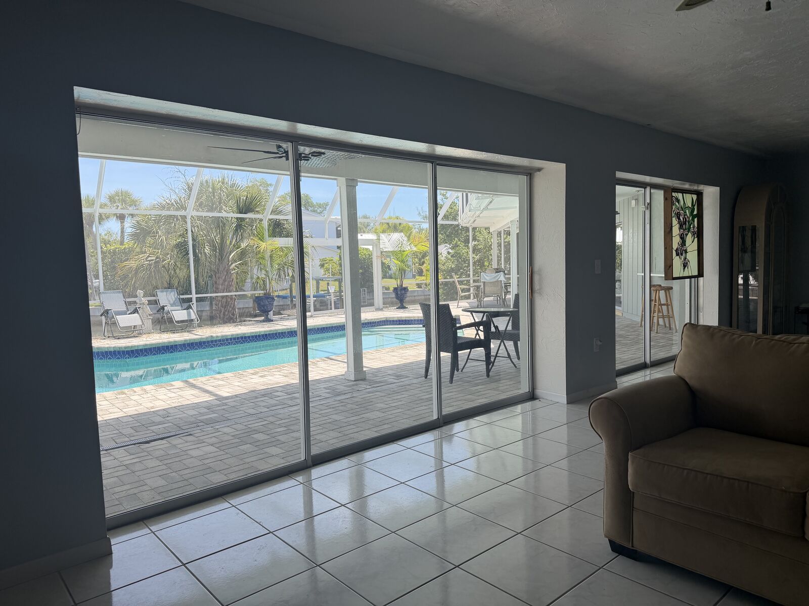 Living room with sliding doors overlooking the pool and water