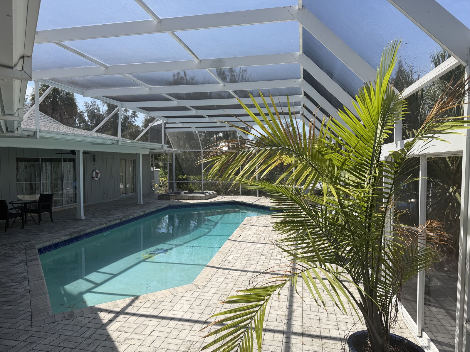 Pool with paver deck and screened lanai